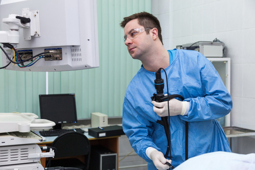 Médico observando el estómago de un paciente